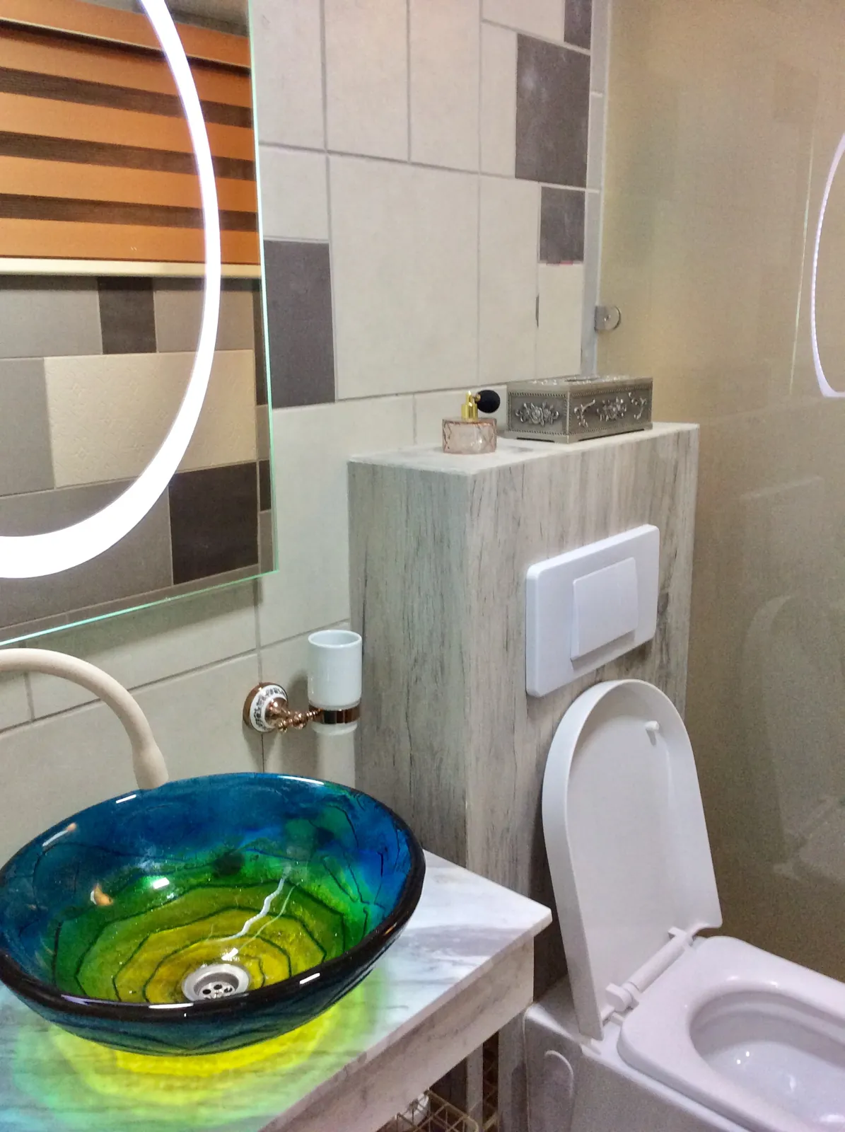 The bathroom with its colorful vessel basin
